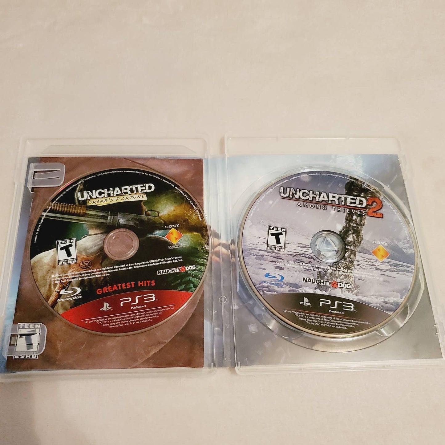 Uncharted 2 Among Thieves PS3 Complete & Drakes Fortune Disc Bundle. Teen. Tested