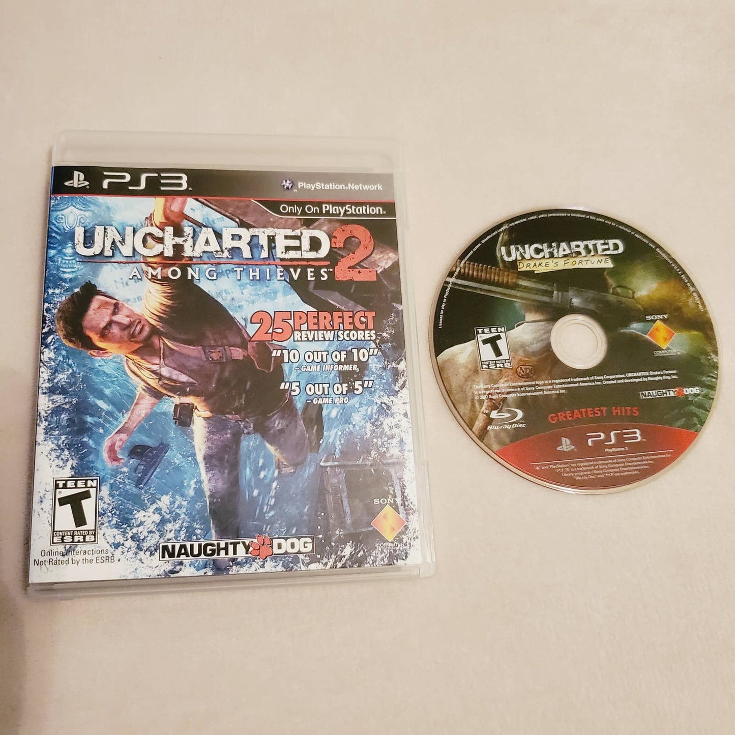 Uncharted 2 Among Thieves PS3 Complete & Drakes Fortune Disc Bundle. Teen. Tested