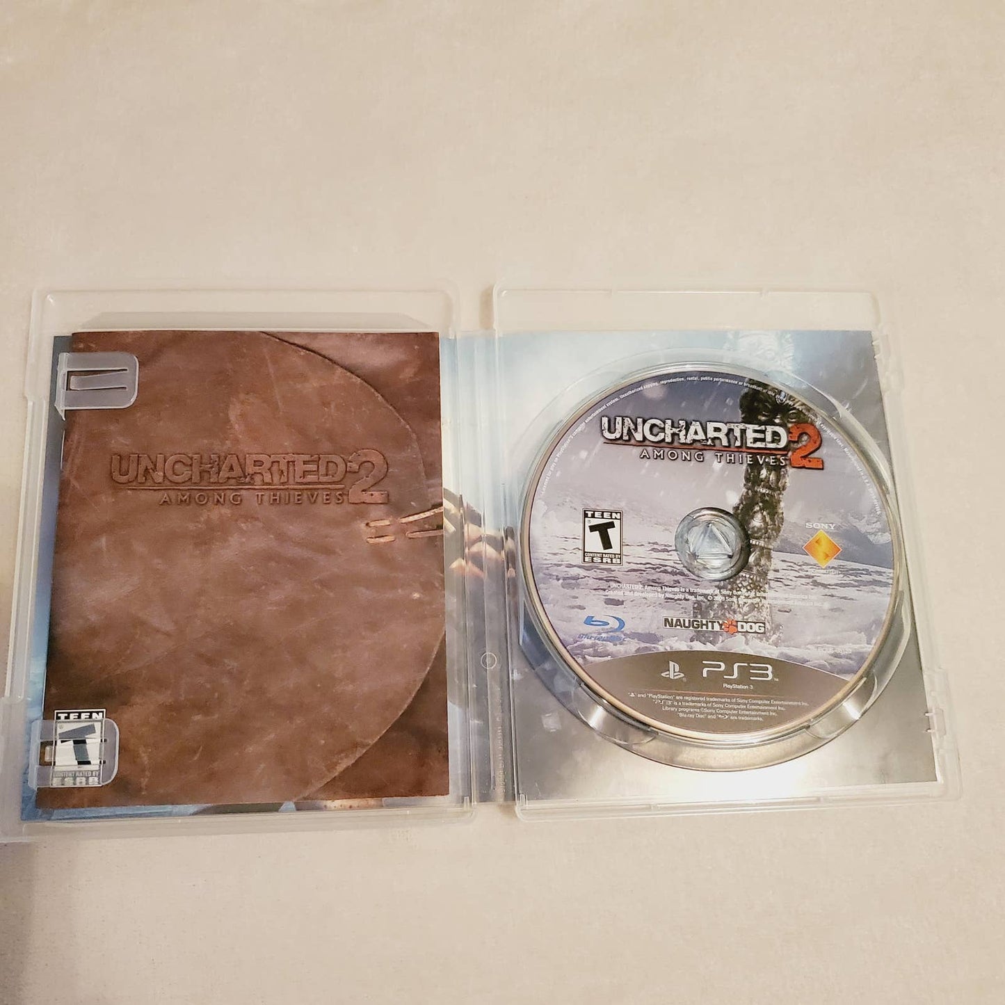 Uncharted 2 Among Thieves PS3 Complete & Drakes Fortune Disc Bundle. Teen. Tested